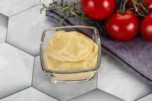 Dijon mustard sauce in the bowl photo