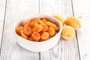 Dried apricot heap in the bowl photo