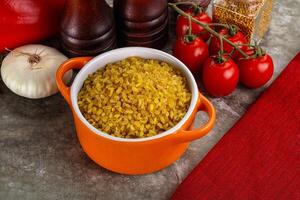 Dry wheat bulgur cereal heap photo