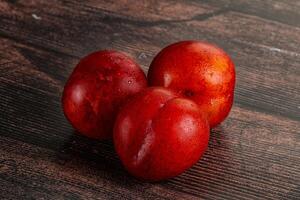 Ripe sweet juicy red plum photo