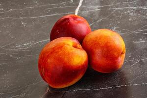 Ripe sweet juicy fresh red nectarines photo