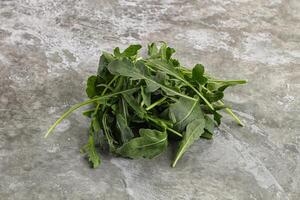 Green Arugula heap over background photo