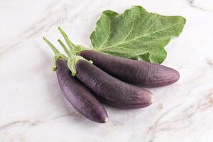 Raw ripe organic eggplant with leaf photo