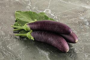 Raw ripe organic eggplant with leaf photo