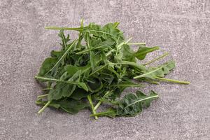 Green Arugula heap over background photo