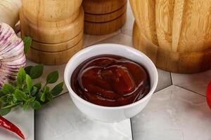 Tasty barbecue sauce in the bowl photo