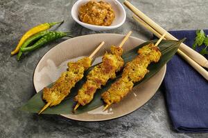 Thai meat skewer Satay with sauce photo