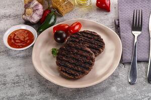 Grilled burger cutlet with sauce photo