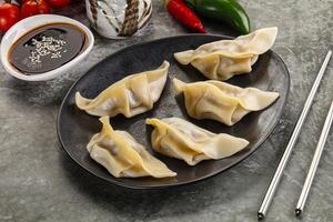 Japanese cuisine - dumplings gyoza with sauce photo