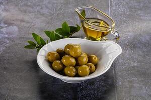 Ripe tasty green olives with branch photo