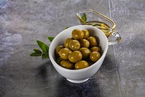 Ripe tasty green olives with branch photo