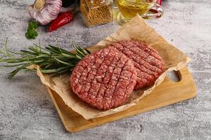 Raw burger cutlet for grill photo