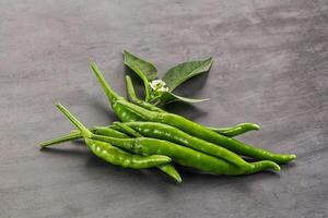 Spicy green chili pepper heap photo