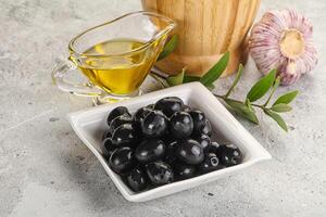 Black olives with oil and branch photo