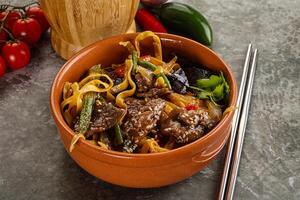 Asian wok with noodle, vegetables and beef photo