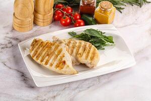 Grilled chicken breast served arugula photo