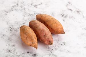 Raw ripe sweet potato heap photo