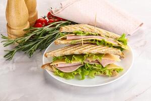 Homemade club sandwich with ham and cheese photo