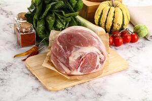 Uncooked raw pork knuckle with spices photo