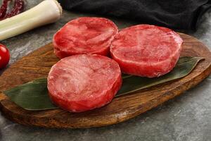 Delicous raw tuna medallion for cooking photo