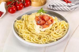 Pasta spaghetti with salmon and stracciatella photo