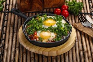 Shakshuka roasted egg in the pan with tomato photo