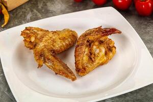 Tasty roasted chicken wing with spices photo