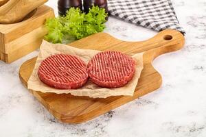 Raw beef  burger cutlet for grill photo