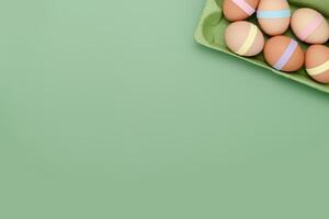 Decorated eggs in carton empty background. Fun Easter background photo