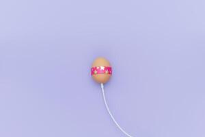 Charging Easter egg with cable. Loading simple background photo