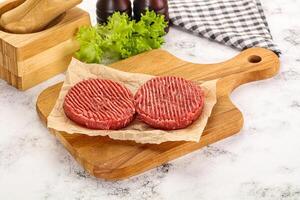 Raw beef  burger cutlet for grill photo