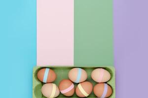Decorated eggs in carton geometric background. Fun Easter background photo