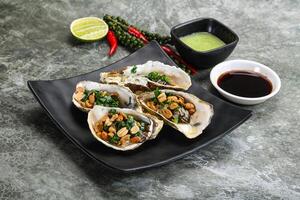 Open half oysters with green onion photo