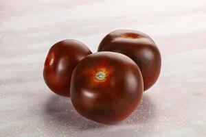 Organic natural juicy Kumato tomato photo