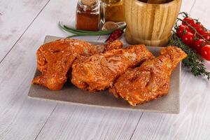 Raw turkey shoulder wing in Indian tandoori marinade photo