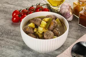 Soup with meatball and potato photo