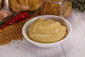 Dijon mustard sauce in the bowl photo