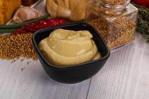 Dijon mustard sauce in the bowl photo