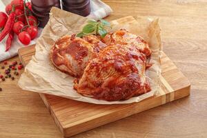 Marinated chicken leg in tomato sauce photo