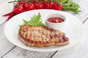 Grilled pork steak with ketchup photo