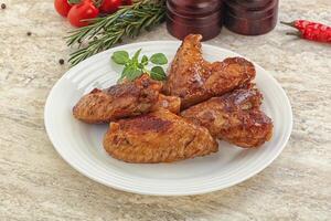 Roasted chicken wings with spicy sauce photo