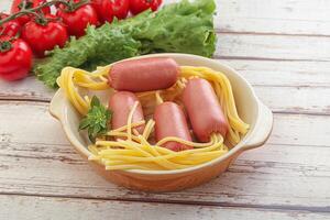 Mini sausages with pasta spaghetti photo