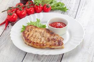 Grilled pork steak with ketchup photo