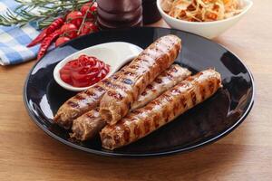 Grilled sausages with cabbage and sauce photo