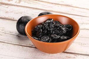 Dry prunes in thw bowl photo