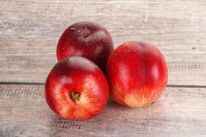 Ripe sweet juicy nectarines heap photo