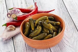 Marinated small cucumbers in the bowl photo