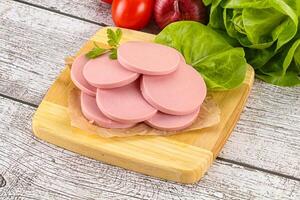 Slices boiled sausages for breakfast photo