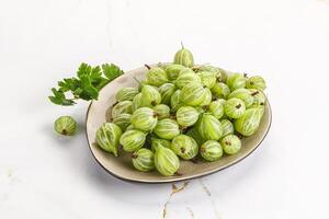 Sweet ripe gooseberries in the bowl photo