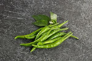 Spicy green chili pepper heap photo